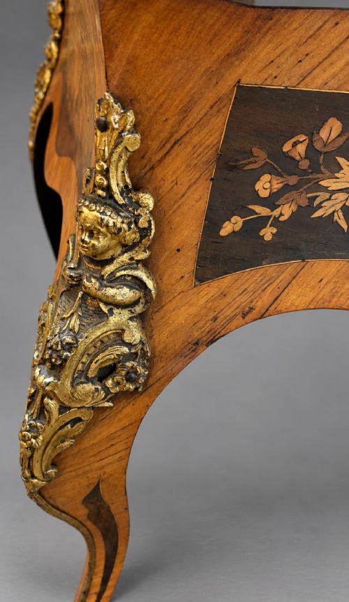 A French Rococo Revival marquetry games table featuring elaborate floral and bird inlay, cast brass mounts, and cabriole legs. View X