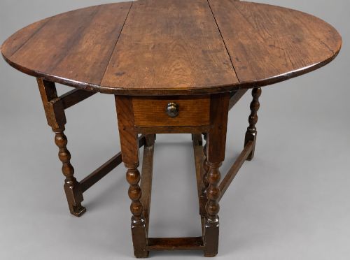 A 17th century gate leg dining table in oak