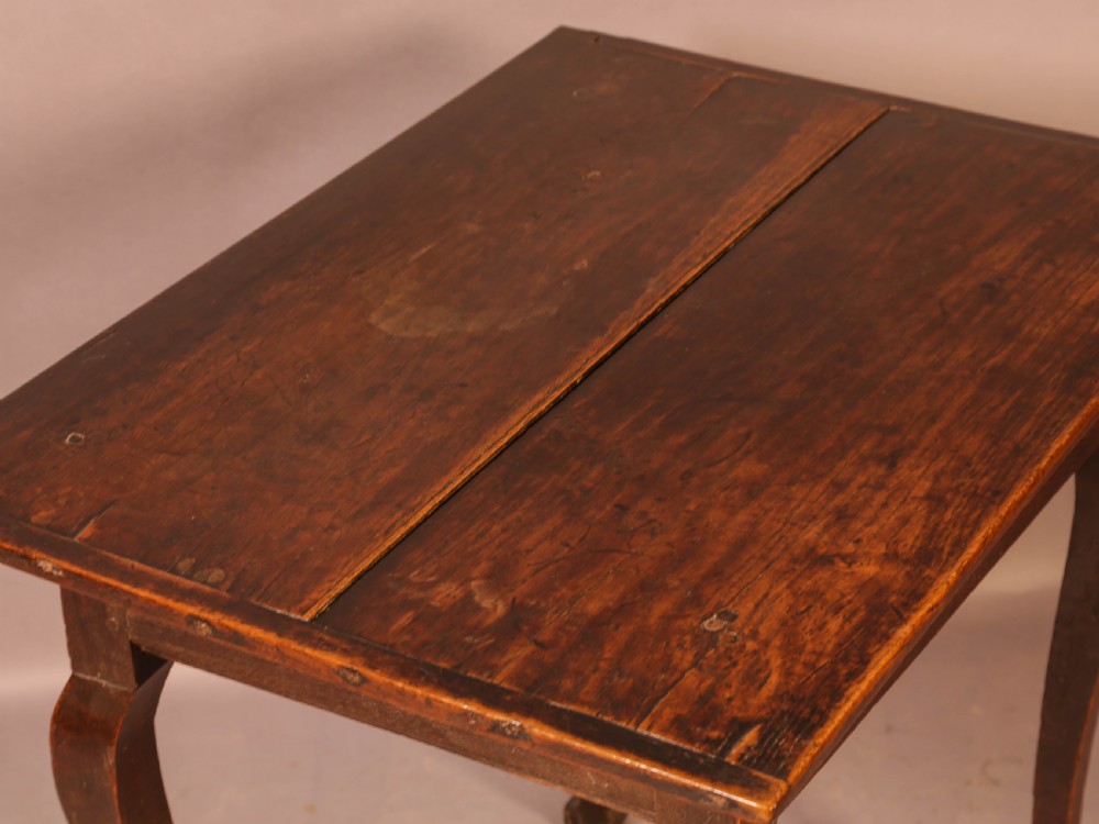 An early 18th-century dark oak side table featuring cabriole legs, a single frieze drawer, and a brass drop handle. View VIII
