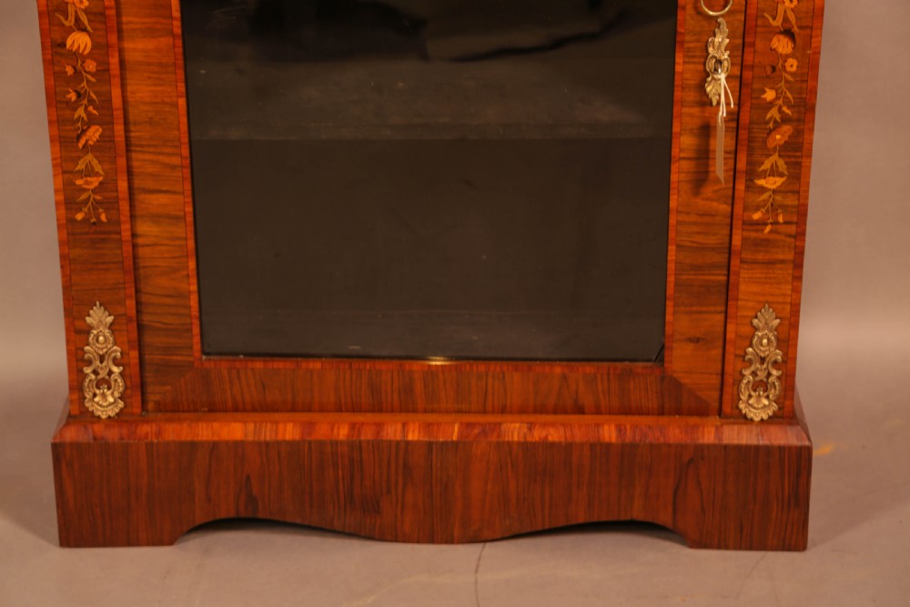 A Victorian figured walnut pier cabinet featuring a single glazed door, floral marquetry inlay, and ornate gilt-metal mounts. View III