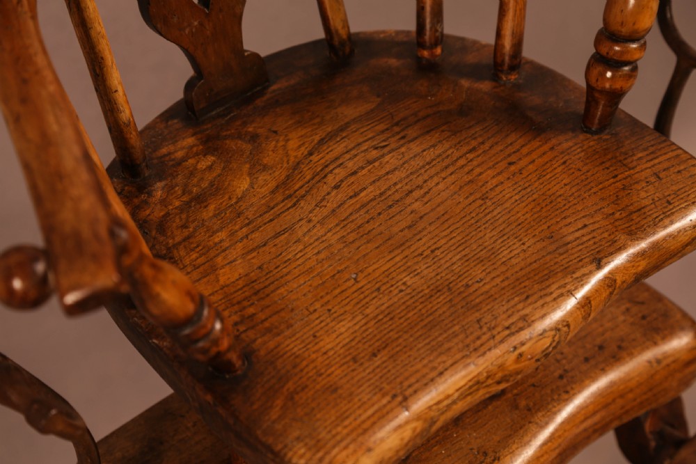 An antique Victorian yew wood child exercise chair featuring a hoop-back top seat, side metal handles, coiled steel springs, and turned legs. View VIII