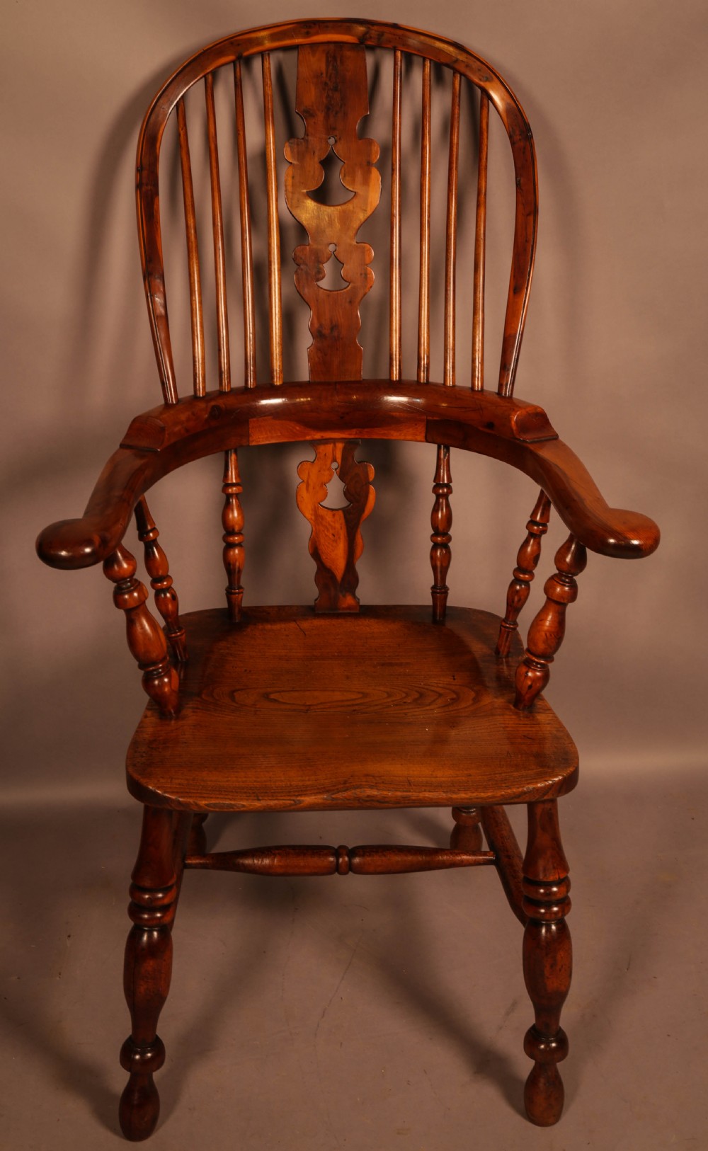 A high-back yew wood Windsor armchair featuring a pierced back splat, spindle backrest, broad armrests, turned legs, and stretchers. View II