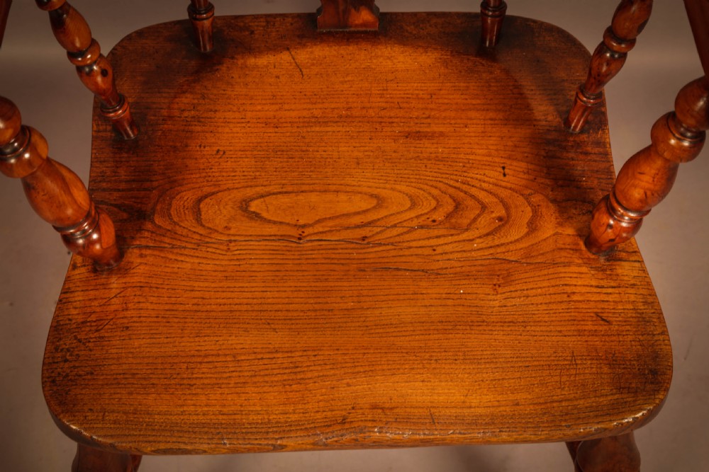 A high-back yew wood Windsor armchair featuring a pierced back splat, spindle backrest, broad armrests, turned legs, and stretchers. View III
