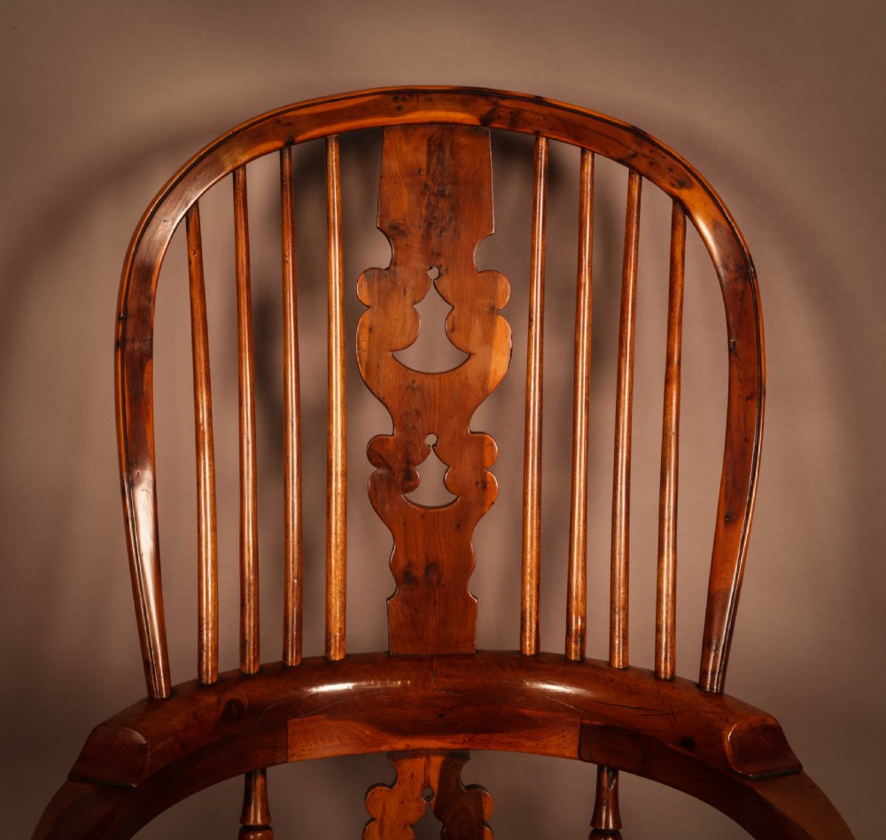 A high-back yew wood Windsor armchair featuring a pierced back splat, spindle backrest, broad armrests, turned legs, and stretchers. View VI