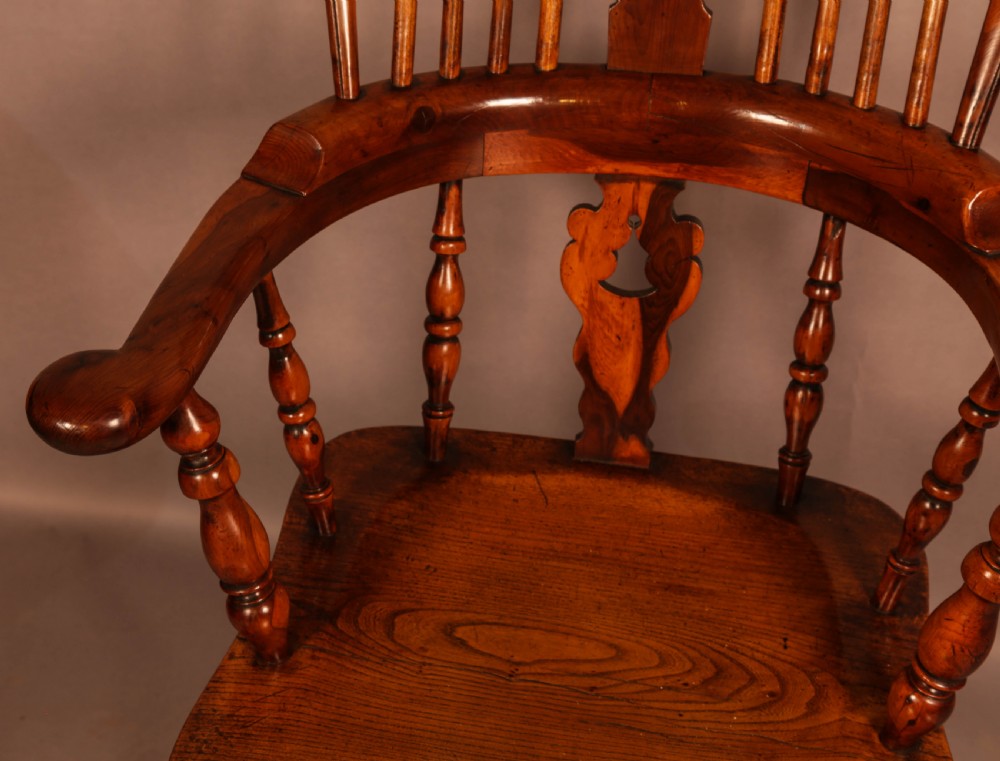 A high-back yew wood Windsor armchair featuring a pierced back splat, spindle backrest, broad armrests, turned legs, and stretchers. View VII