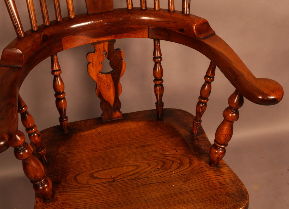A high-back yew wood Windsor armchair featuring a pierced back splat, spindle backrest, broad armrests, turned legs, and stretchers. View VIII