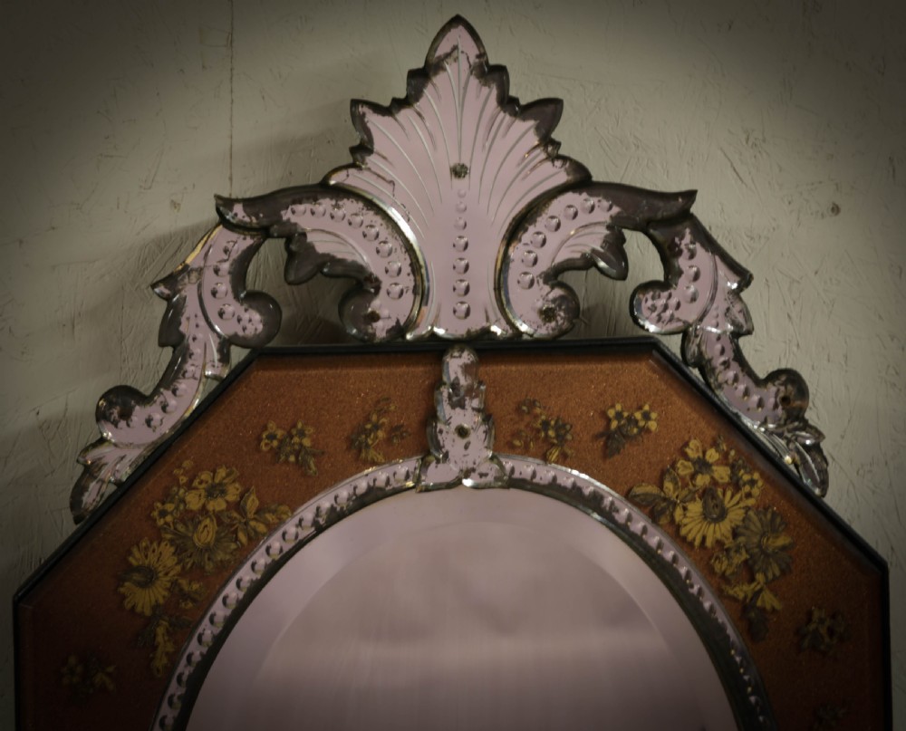 An octagonal Venetian wall mirror with a central oval plate, amber etched glass borders, and a decorative glass top crest. View II
