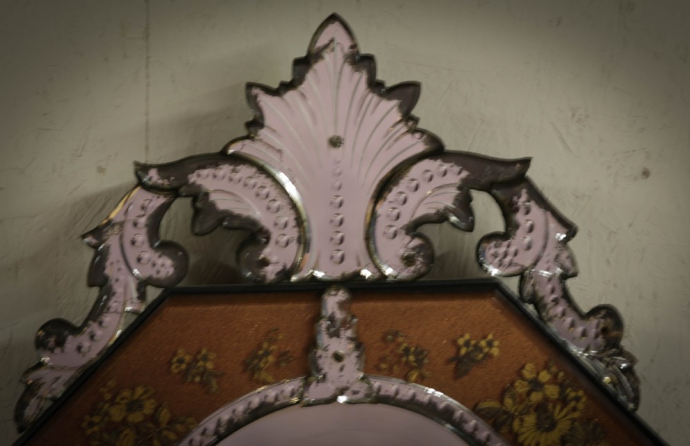 An octagonal Venetian wall mirror with a central oval plate, amber etched glass borders, and a decorative glass top crest. View III