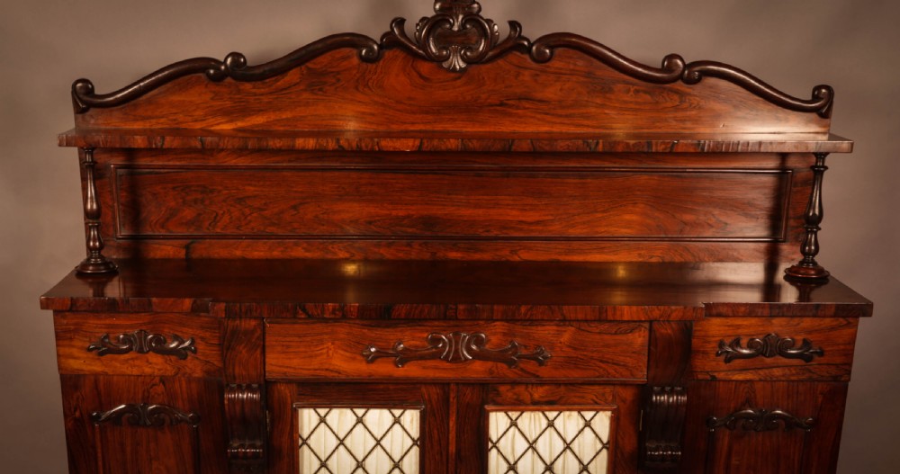 A Victorian rosewood four-door chiffonier featuring central wire latticework panels and a raised carved cresting rail on the backboard. View III