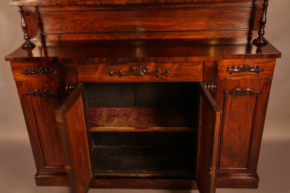 A Victorian rosewood four-door chiffonier featuring central wire latticework panels and a raised carved cresting rail on the backboard. View VII
