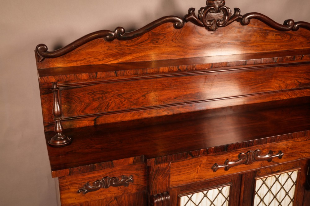 A Victorian rosewood four-door chiffonier featuring central wire latticework panels and a raised carved cresting rail on the backboard. View VIII