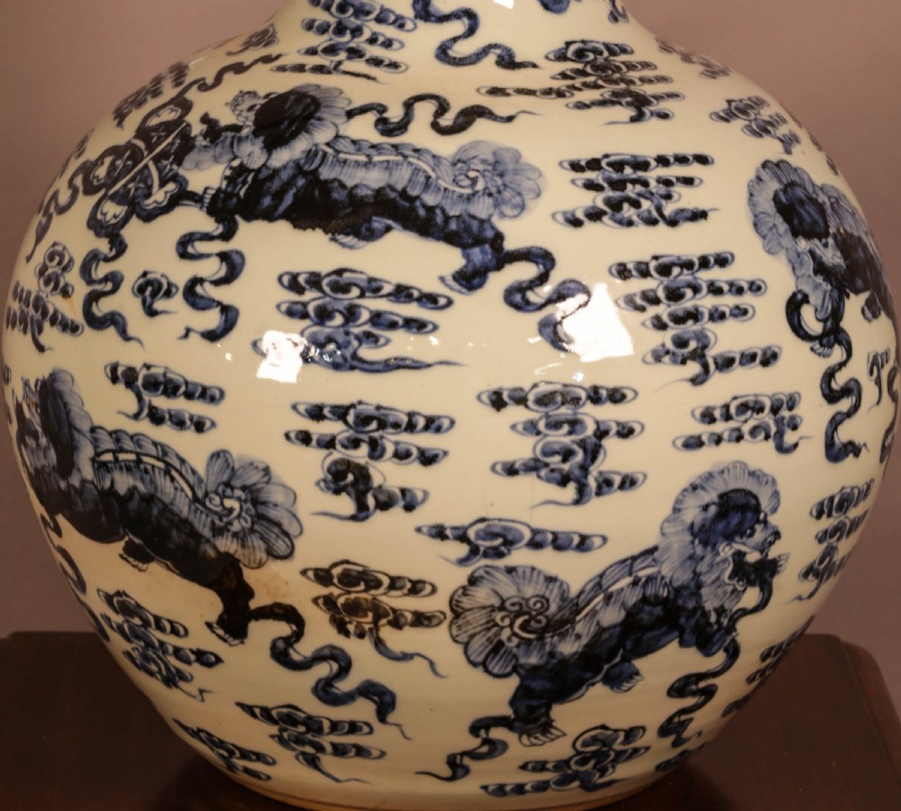 A large cylindrical and globular porcelain vase featuring hand-painted blue foo dogs and cloud motifs against a white glaze. View III