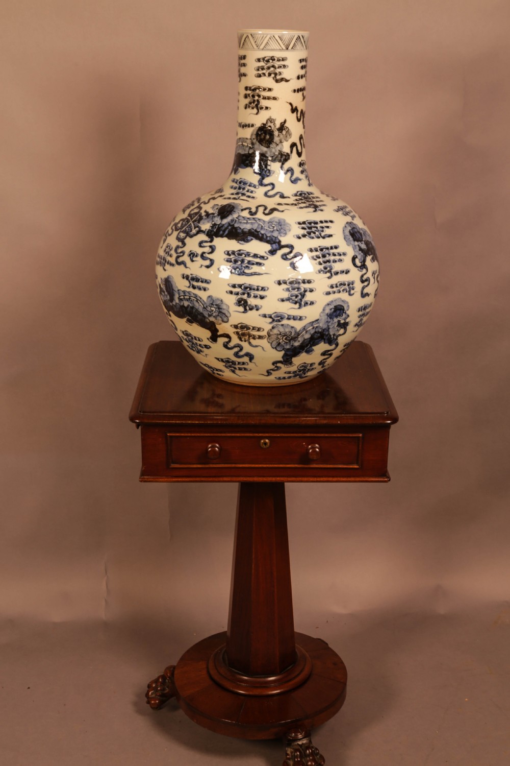 A large cylindrical and globular porcelain vase featuring hand-painted blue foo dogs and cloud motifs against a white glaze. View V