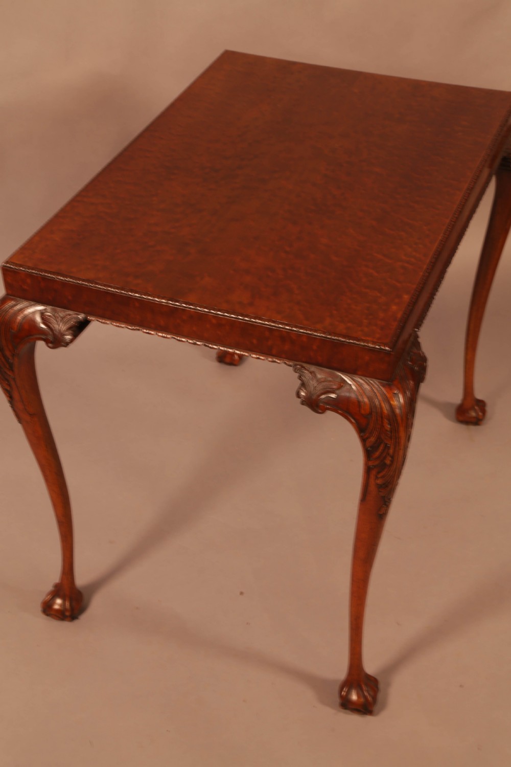 A Chippendale style wooden silver table featuring cabriole legs with carved knees, ball and claw feet, and a rectangular burr-veneered top. View II
