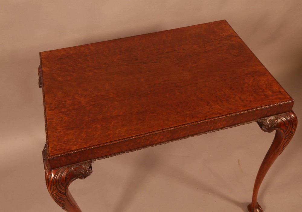 A Chippendale style wooden silver table featuring cabriole legs with carved knees, ball and claw feet, and a rectangular burr-veneered top. View V