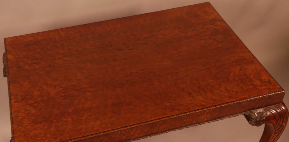 A Chippendale style wooden silver table featuring cabriole legs with carved knees, ball and claw feet, and a rectangular burr-veneered top. View VI