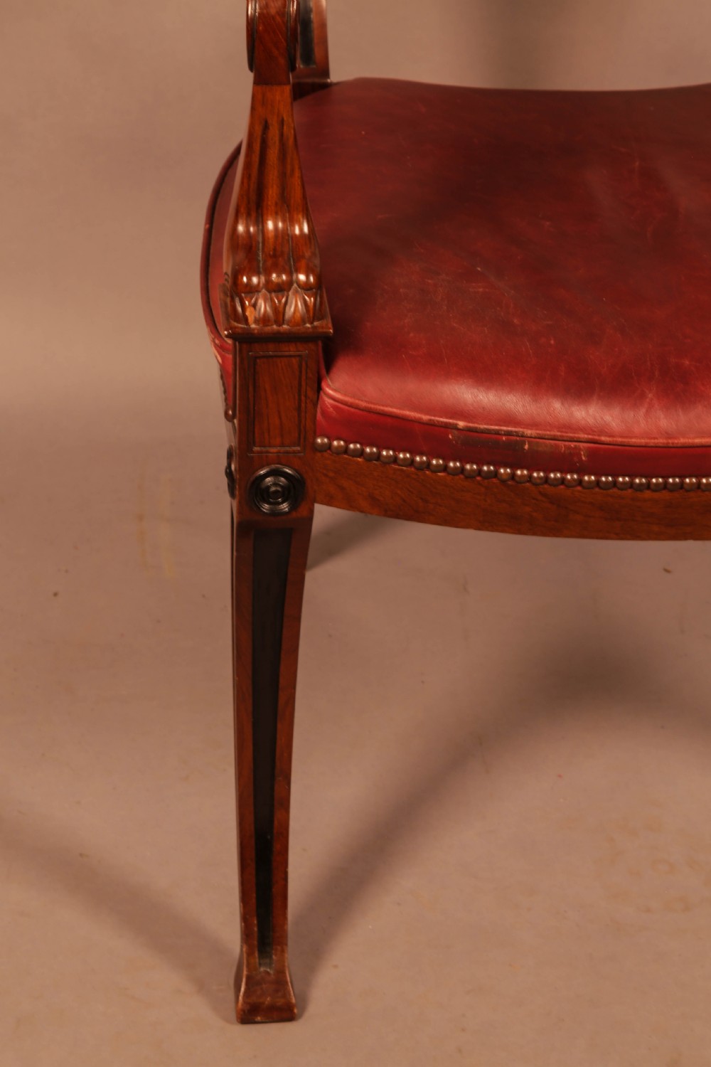 A pair of Regency mahogany carver chairs featuring red leather seats, sabre legs, ebony Greek key inlay, and the name Henry Maxwell gilt-stamped across the top rails. View VI