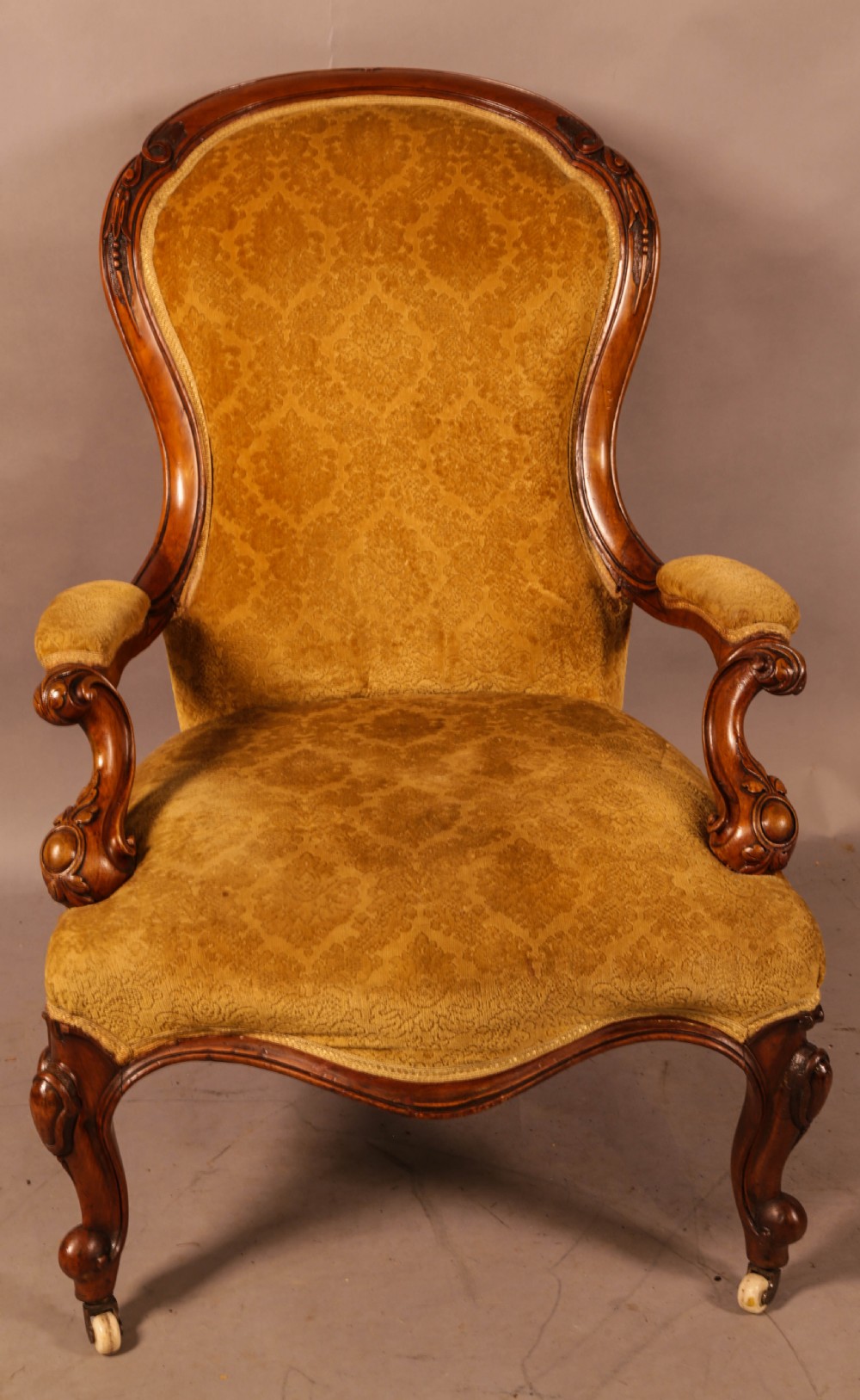 A Victorian Walnut spoon back armchair