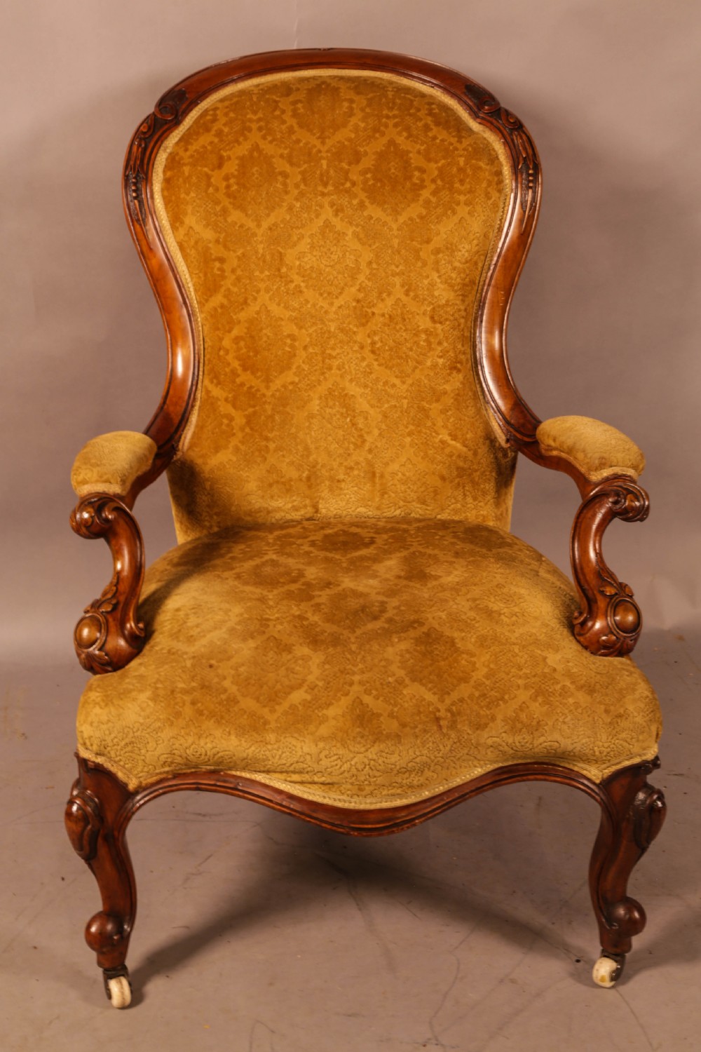 A Victorian Walnut spoon back armchair View II
