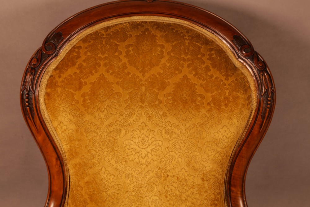 A Victorian Walnut spoon back armchair View VI