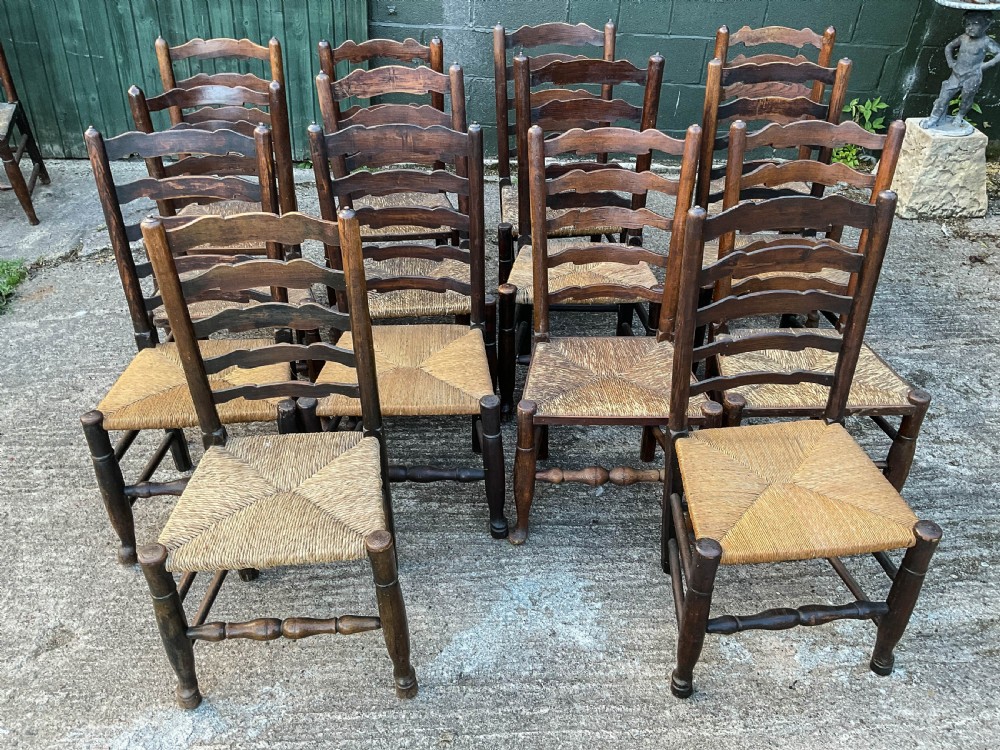 a harlequin set of 12 early 19th century ladder back chairs