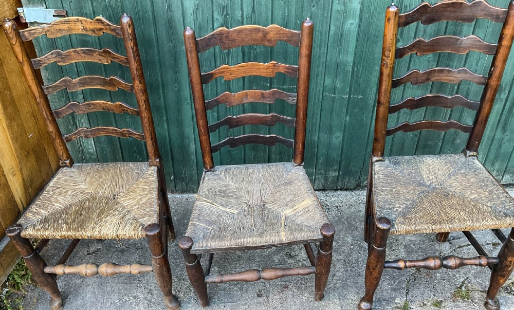 a harlequin set of 12 early 19th century ladder back chairs View XI
