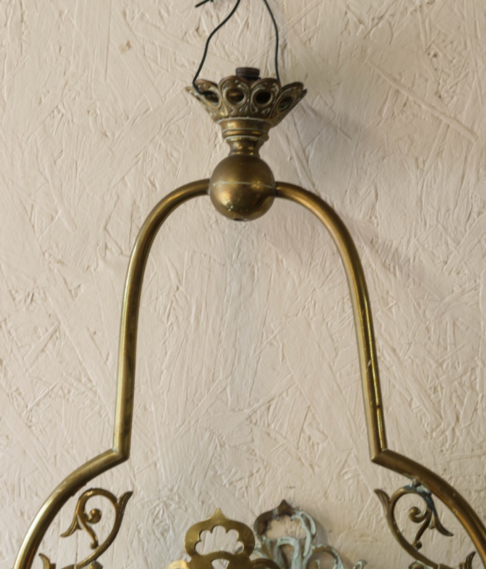 Victorian brass hanging lantern featuring an ornate scrollwork frame enclosing a cylindrical shade with graded yellow and red glass. View VI