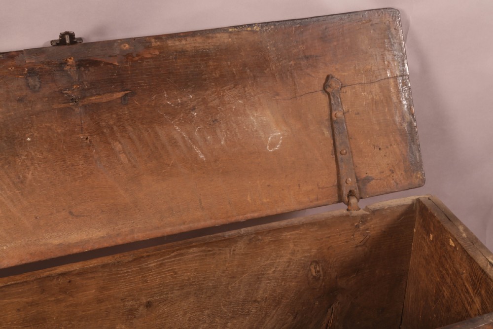 A dark oak early seventeenth-century five-plank coffer featuring carved lozenge panel decoration and hand-forged iron hardware. View VII