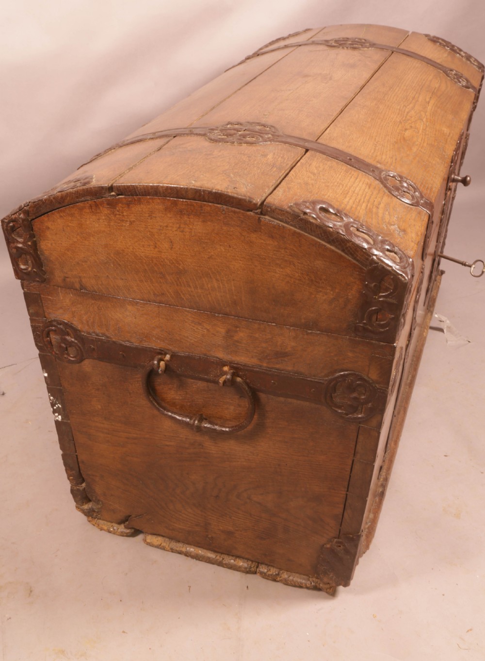 An 18th-century oak trunk with a domed lid and decorative iron strapwork. View VIII
