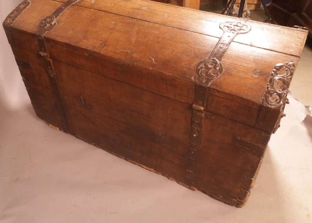 An 18th-century oak trunk with a domed lid and decorative iron strapwork. View IX