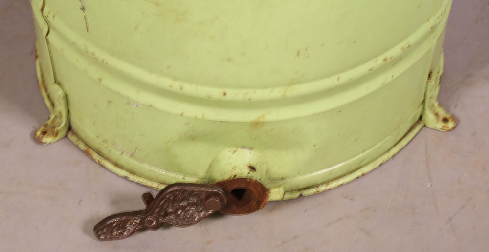 A pale green cylindrical metal honey separator with a top-mounted cast iron hand-crank mechanism and wooden handle. View VII