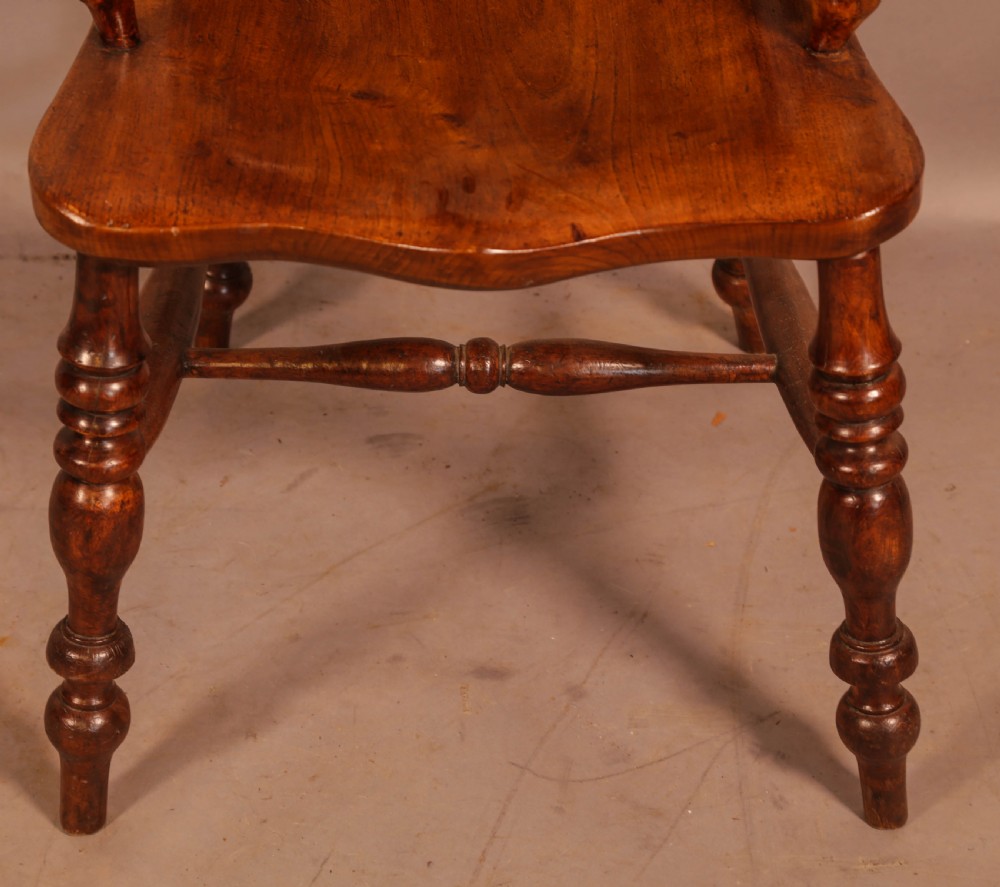 An antique yew wood Windsor armchair featuring a bowed hoop back, pierced splat, turned legs, and a solid elm seat. View IV