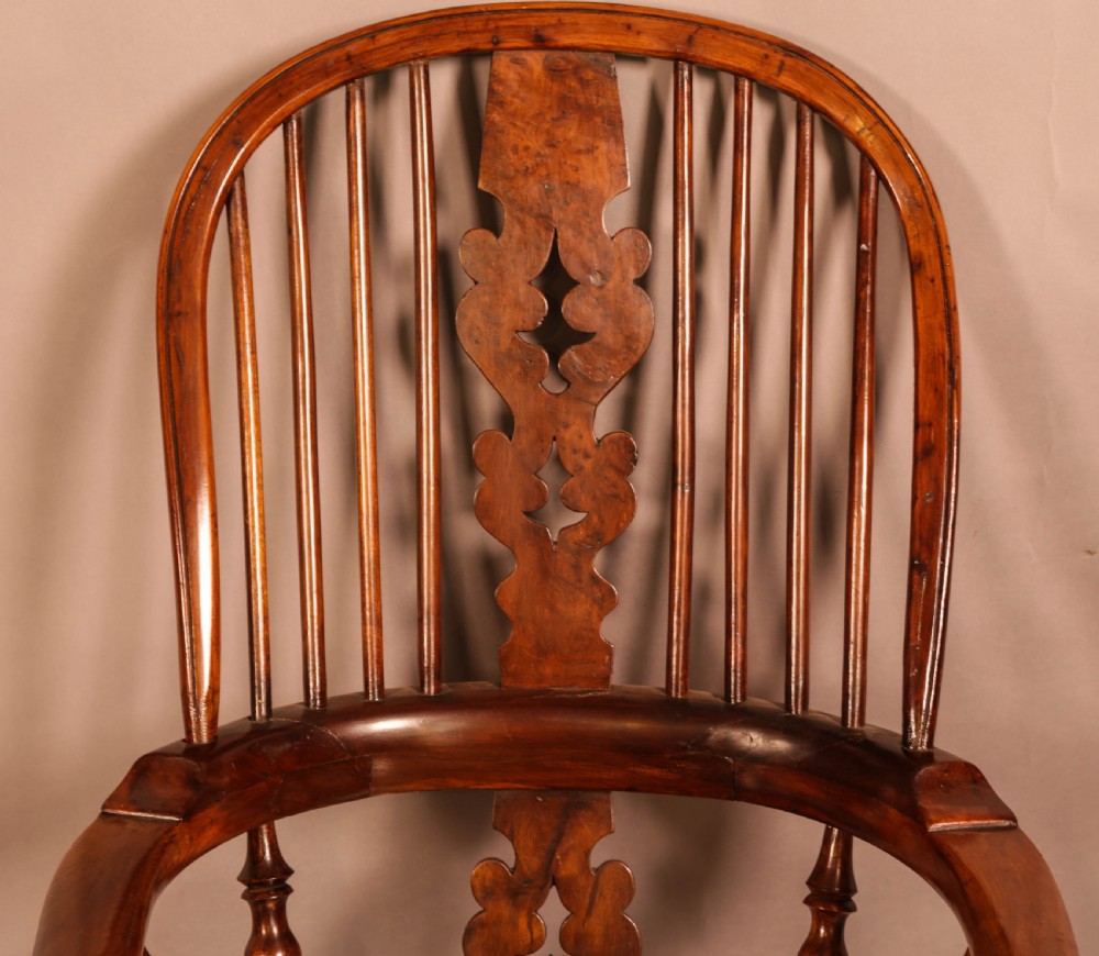 An antique yew wood Windsor armchair featuring a bowed hoop back, pierced splat, turned legs, and a solid elm seat. View VI