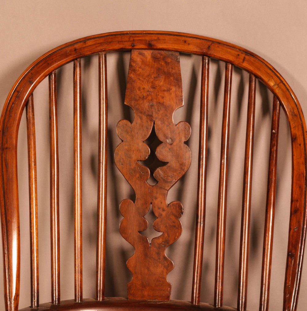 An antique yew wood Windsor armchair featuring a bowed hoop back, pierced splat, turned legs, and a solid elm seat. View VIII