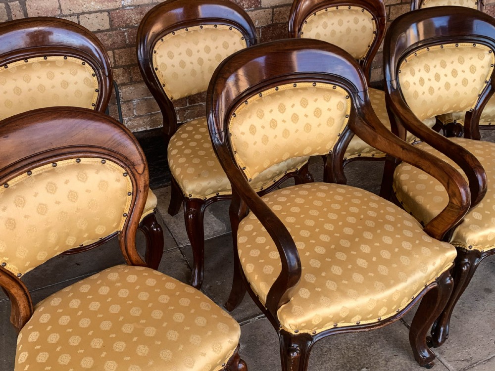A set of eight Victorian mahogany dining chairs featuring gold patterned fabric upholstery, balloon backs, and cabriole legs. View III