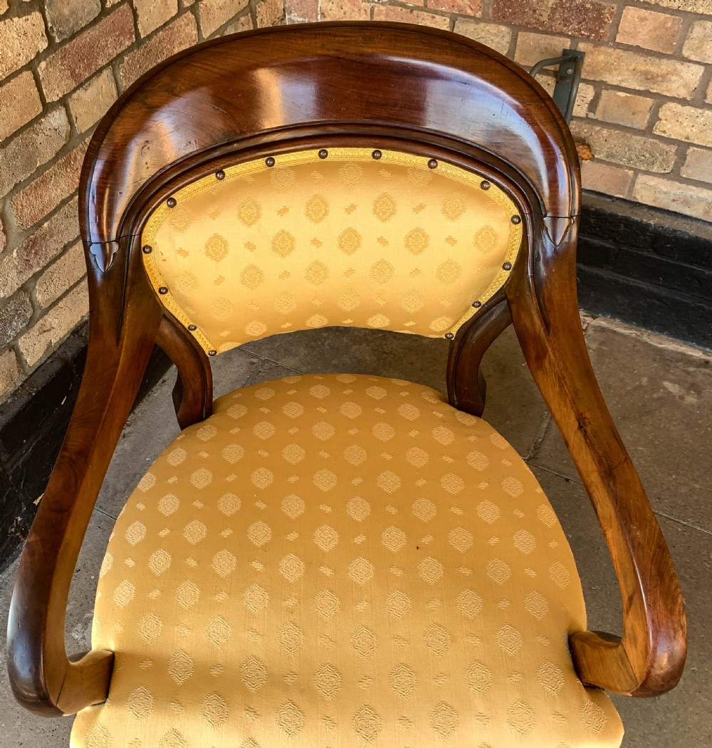 A set of eight Victorian mahogany dining chairs featuring gold patterned fabric upholstery, balloon backs, and cabriole legs. View IX