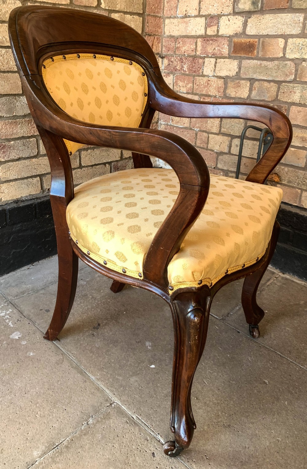 A set of eight Victorian mahogany dining chairs featuring gold patterned fabric upholstery, balloon backs, and cabriole legs. View X