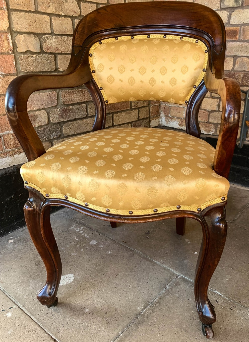 A set of eight Victorian mahogany dining chairs featuring gold patterned fabric upholstery, balloon backs, and cabriole legs. View XII