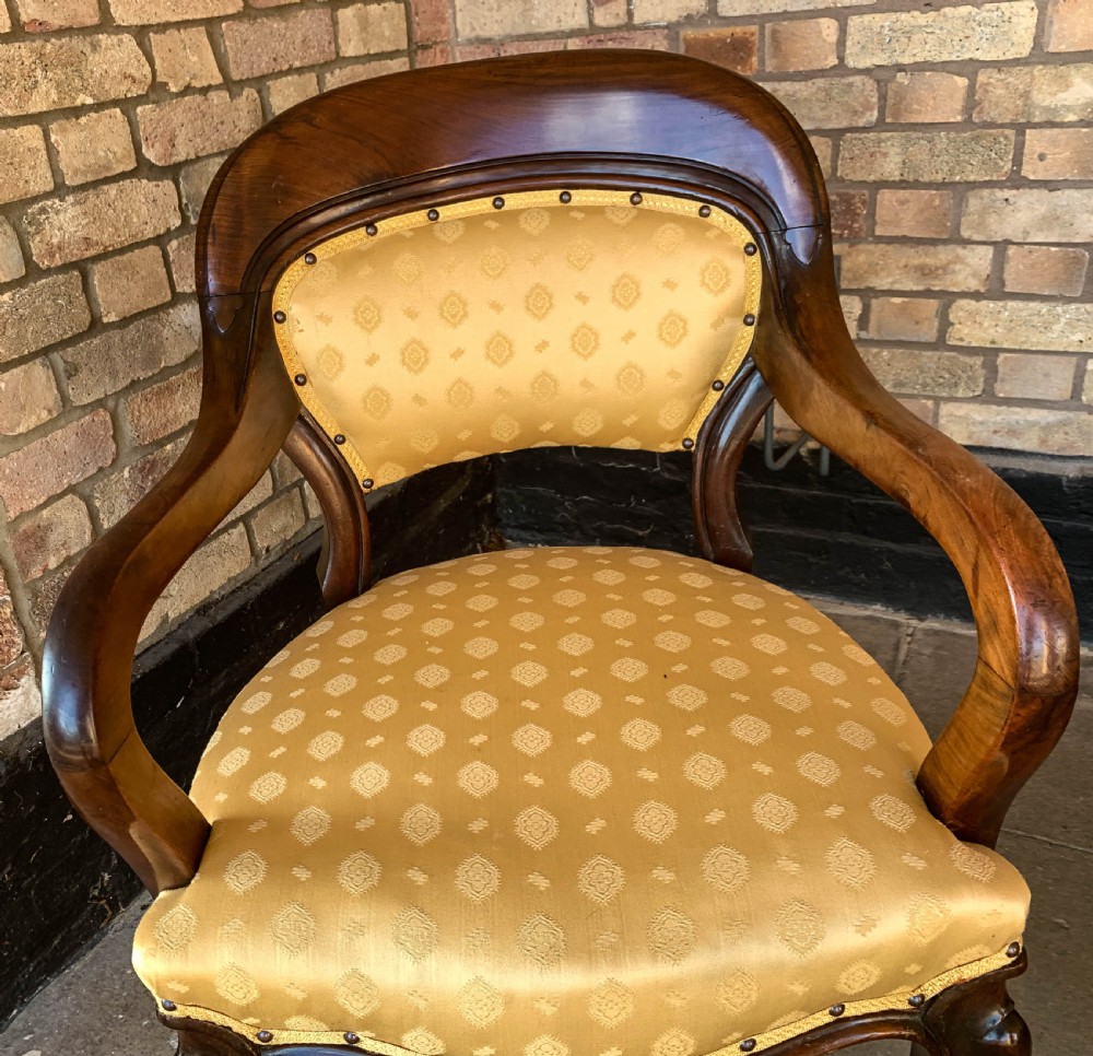 A set of eight Victorian mahogany dining chairs featuring gold patterned fabric upholstery, balloon backs, and cabriole legs. View XIII