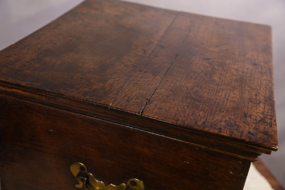 An 18th-century oak close stool designed with four faux drawer fronts, brass drop handles, and bracket feet. View VII