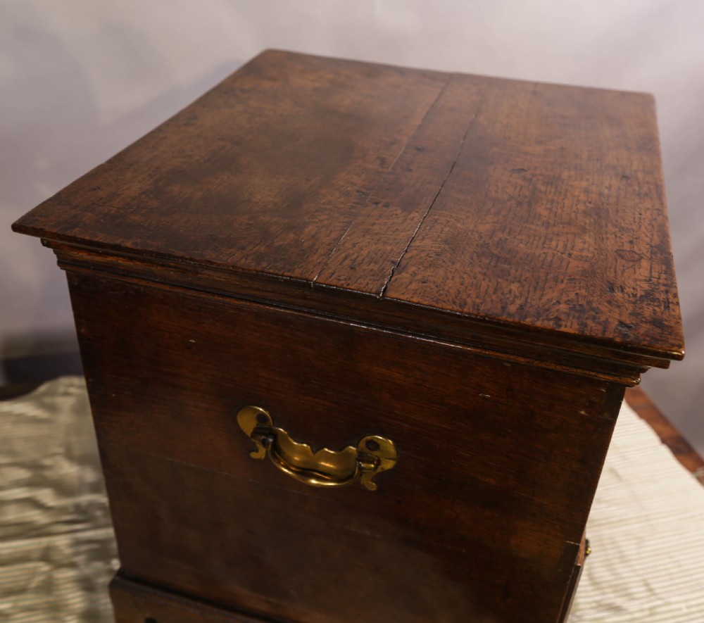 An 18th-century oak close stool designed with four faux drawer fronts, brass drop handles, and bracket feet. View IX
