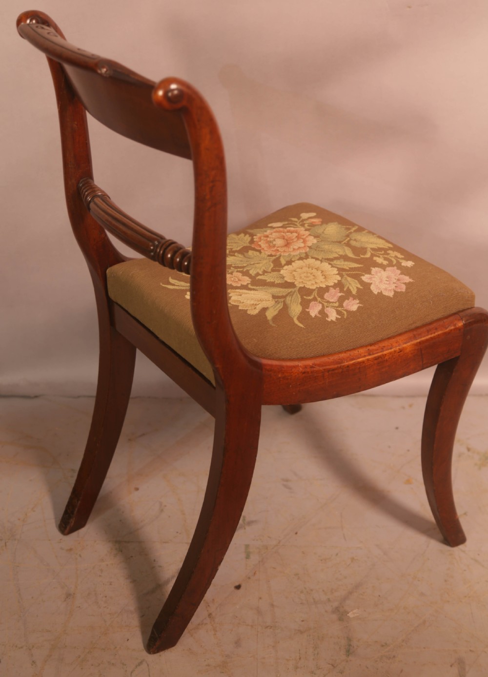 A matched set of eight Regency mahogany dining chairs featuring brass inlay on the top rails and upholstered seats. View X