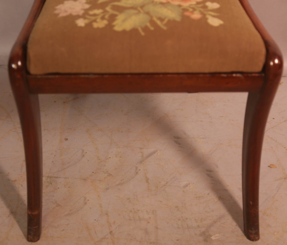 A matched set of eight Regency mahogany dining chairs featuring brass inlay on the top rails and upholstered seats. View XI