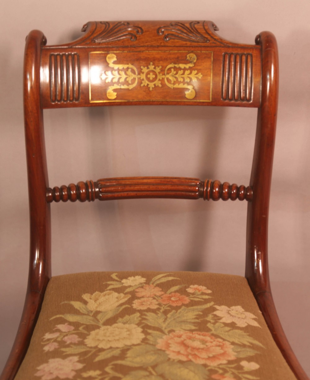 A matched set of eight Regency mahogany dining chairs featuring brass inlay on the top rails and upholstered seats. View XII