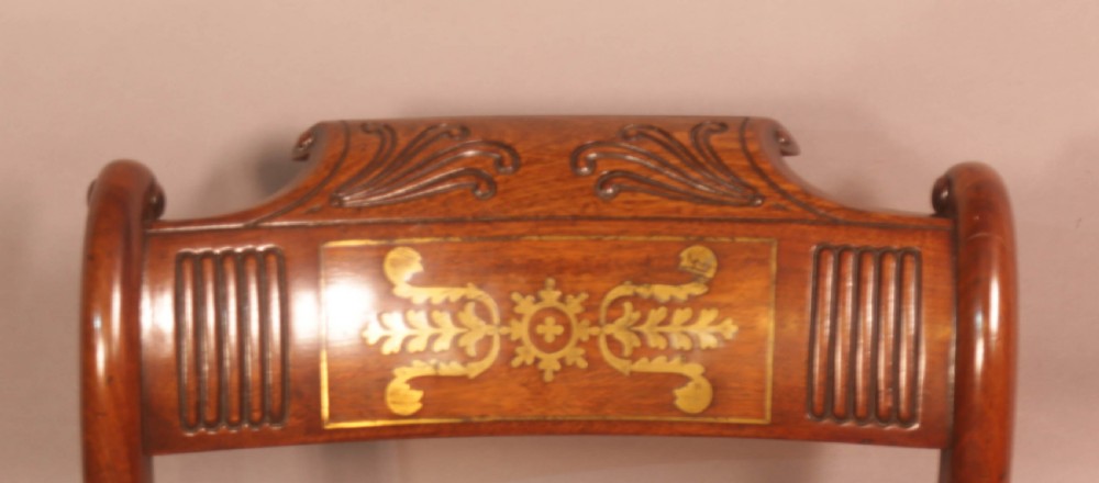 A matched set of eight Regency mahogany dining chairs featuring brass inlay on the top rails and upholstered seats. View XIV
