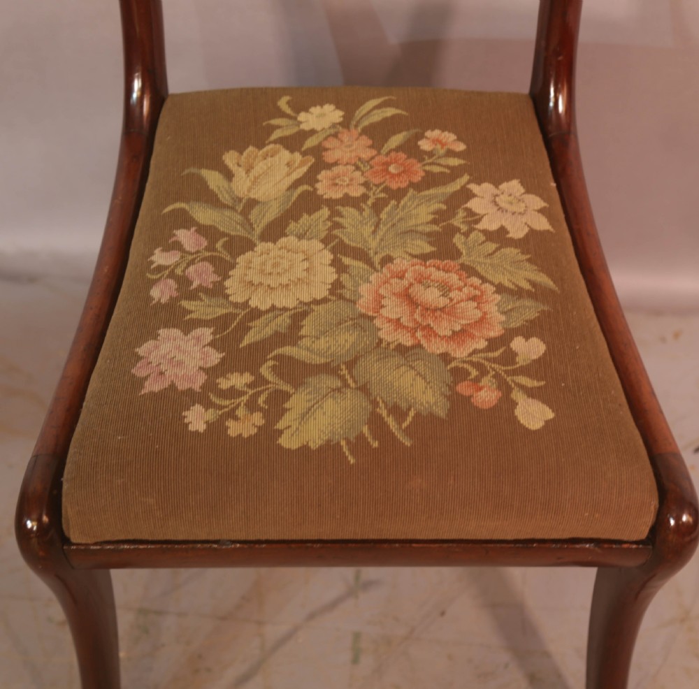 A matched set of eight Regency mahogany dining chairs featuring brass inlay on the top rails and upholstered seats. View XVII