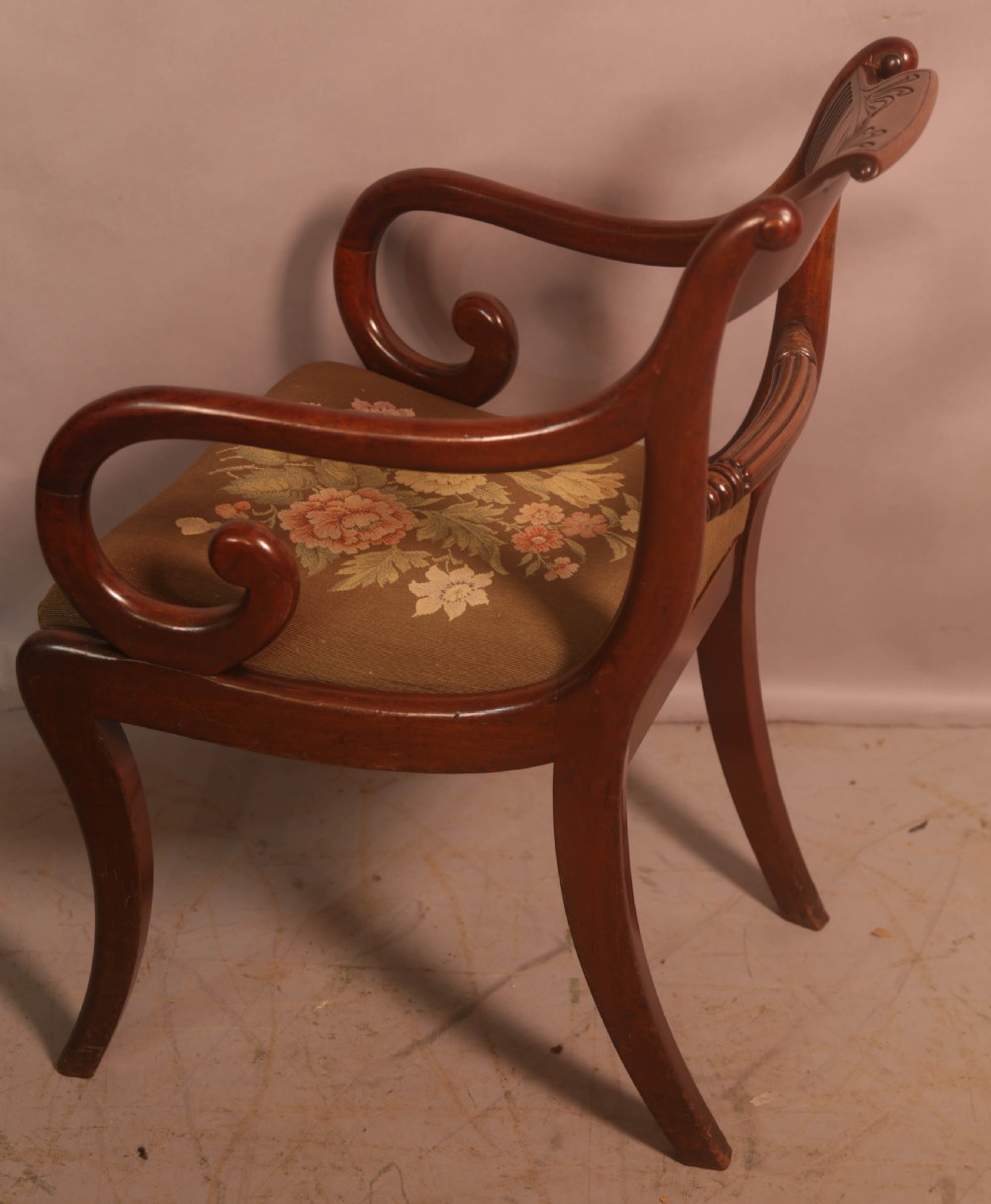 A matched set of eight Regency mahogany dining chairs featuring brass inlay on the top rails and upholstered seats. View XX