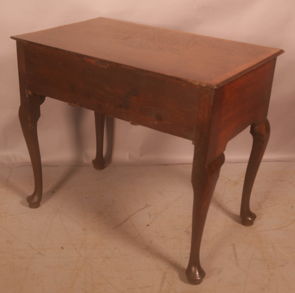 An eighteenth-century oak side table featuring a rectangular top, cabriole legs, and three drawers with brass drop handles. View IX