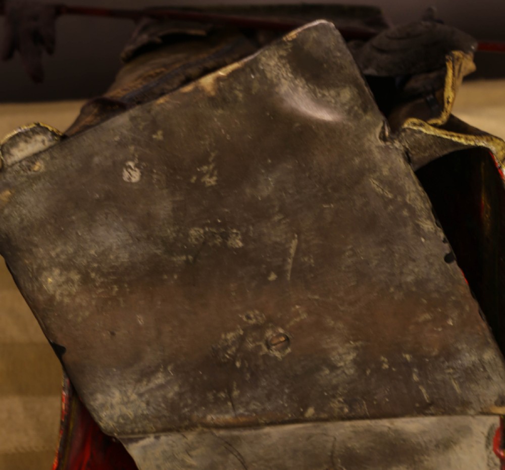A cold-painted bronze sculpture depicting a bedouin tent with patterned yellow draping, a green domed top, and accompanying miniature weapons. View II