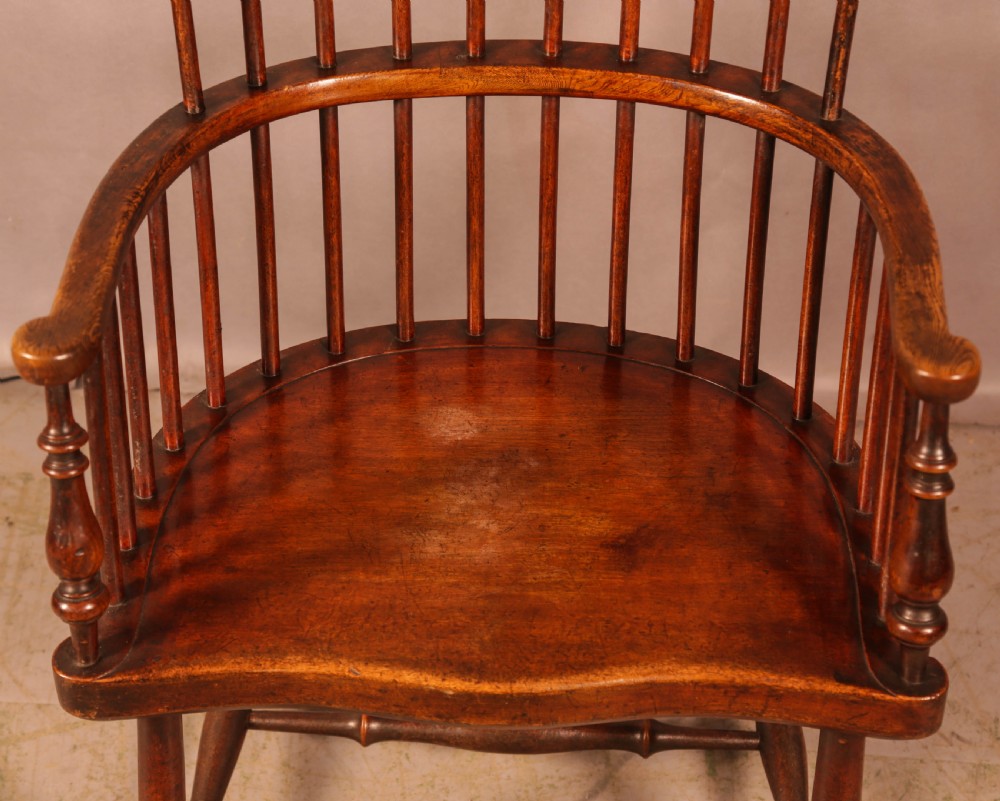 A high-back Scottish Darvel Windsor armchair crafted from warm brown wood, featuring a comb crest rail, spindle back, curved arm bow, and saddle seat. View VIII